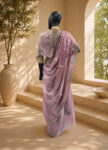 A beautiful baby pink Jimmy Choo jorjet Saree featuring handwoven details and a delicate drape – front