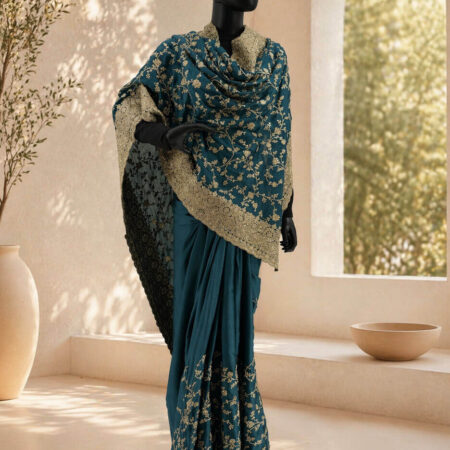 A teal blue saree with intricate golden zari work - front
