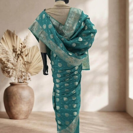 Draped in tradition, this blues green Chennai Katan saree with intricate gold stone zari work is a timeless piece of elegance - bac