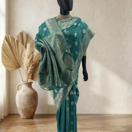 Draped in tradition, this blues green Chennai Katan saree with intricate gold stone zari work is a timeless piece of elegance - fro